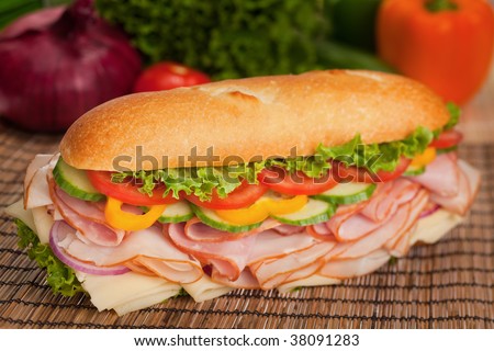 Large sub with fresh veggies, cheese, turkey and ham