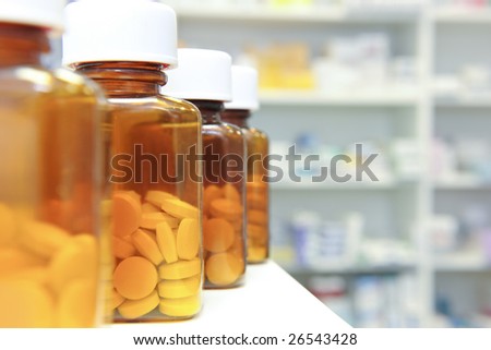 row of bottles and pills on a chemists counter