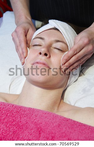 woman having a facial treatment in beauty salon