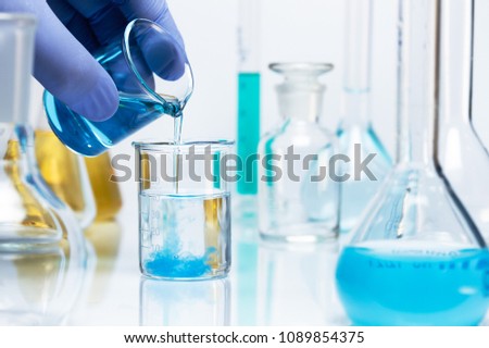 Chemical reaction. Blue precipitate is formed in a beaker as a result of a chemical reaction.