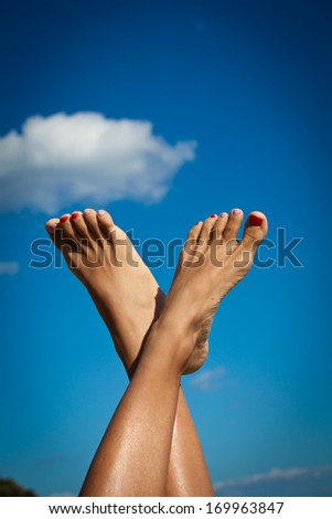 Women\'s sexy legs on the sky. Summer vacations concept