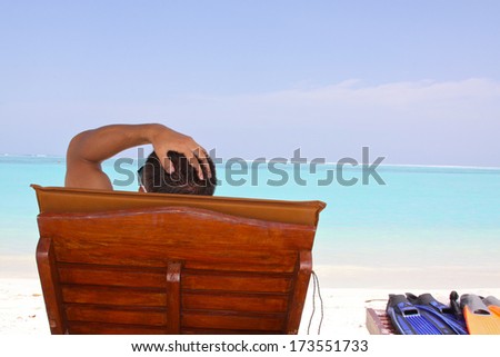 Man relax on a colorful beach in Maldives. Summer vacation