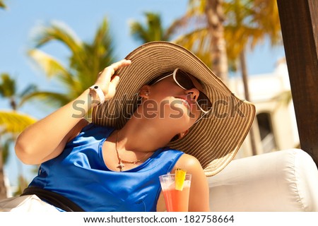 Portrait of a beautiful woman on vacation in luxury resort. Fresh pretty brunette in sunset light. Travel holidays vacation.