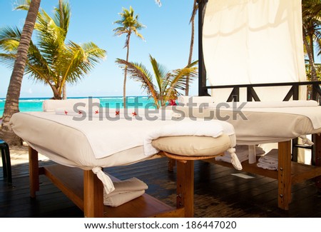 Tropical massage setting. Spa salon at the beach of tropical island - health care background.