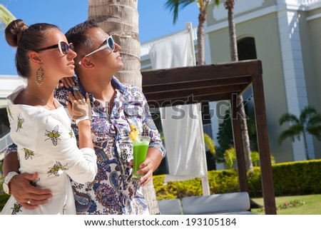 Outdoor fashion portrait of young sensual couple in vacation. Fashion glamorous shot vacation resort spring-summer