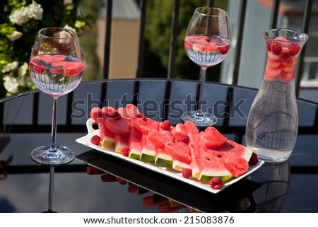 Romantic breakfast with fresh slices of red watermelon and raspberry