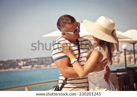 Portrait of a loving young couple standing and holding each other on the Promenade. Love in the sun. French Riviera.