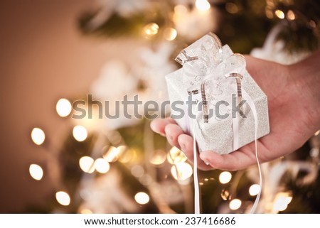 Small gift box in man hand - christmas present, luxury life