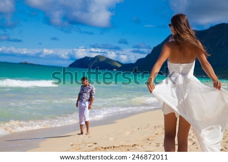 Cool trendy modern couple on summer holidays vacation on tropical Hawaiian beach. Enjoying every minute of this vacation. Hawaiian Island of Oahu