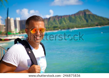 Portrait of man on travel vacation holidays on Hawaiian Waikiki beach with Diamond Head. Vacations And Tourism Concept. Summer luxury vacation in Hawaii.