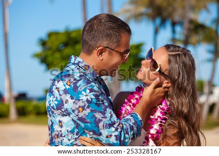 Shot of young couple enjoying beach getaway. Couple in love, summer luxury vacation in Hawaii. Travel holidays concept. Living, loving and laughing