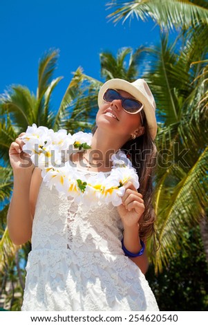 Happy people. Beautiful woman with welcoming Lei cheerful, happiness during summer vacation holidays on Hawaii. Luxury vacation