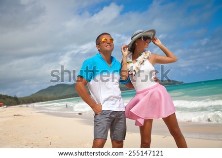 Shot of young couple enjoying beach getaway. Couple in love, summer luxury vacation in Hawaii. Travel, romantic holidays concept. Enjoying every minute of this vacation.