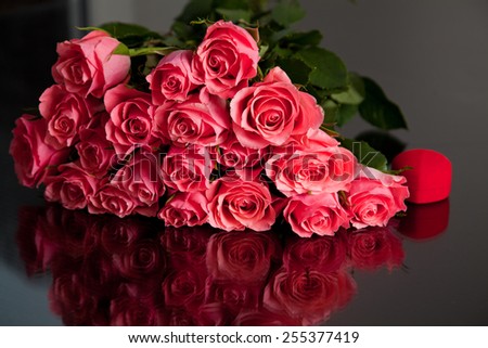 Big bouquet of pink roses with red gift box. Beautiful romantic bouquet. Holidays and celebrations