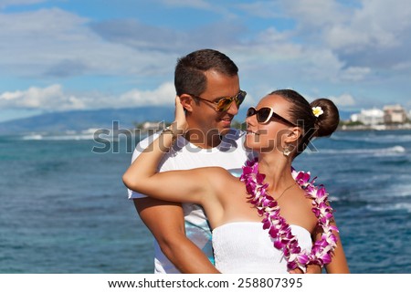Happy young lovers enjoying every moment together. Beautiful couple in love. Couple in love, summer luxury vacation in Hawaii. Travel holidays concept. Living, loving and laughing