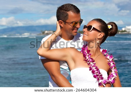 Young couple relaxing together enjoying their holidays in perfect getaway in sunny tropical destination. Couple in love, summer luxury vacation in Hawaii. Living, loving and laughing