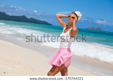 Free happy woman holding hand behind head, relaxing at the luxury resort, enjoying breathing freely fresh air. Summer luxury vacation. Hawaiian Island of Oahu
