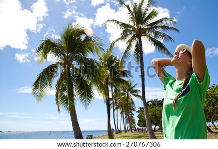 Freedom beach woman. Happy young woman meditation enjoying summer sun and tanning during holidays on Hawaii. Summer luxury vacation. Hawaiian Island of Oahu