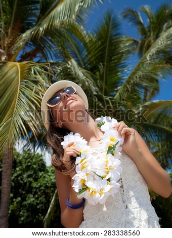 Happy beautiful people. Girl in white dress with welcoming Lei cheerful, happiness during summer vacation holidays on Hawaii. Hawaiian travel vacations in Waikiki, Honolulu city, Oahu, Hawaii, USA.