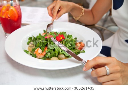 Female hands with a dinner. Romantic Dinner or lunch in a gourmet restaurant. (selective focus)