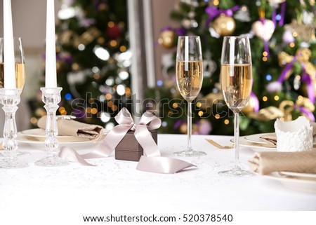 Christmas gifts on the beautiful table with Christmas tree on background. Holidays and celebration concept