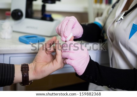 A woman doctor taking blood test no face close look