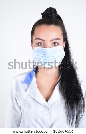Young nurse doctor in a  medicine mask studio isolated