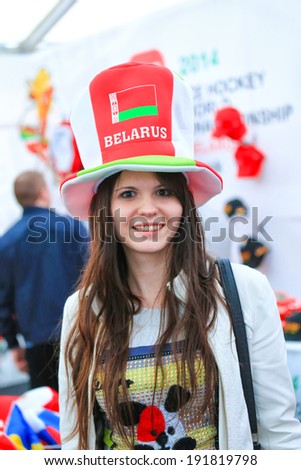 Minsk, Belarus - May 9,2014: Belarussian fan woman in a fan hat smiling on a street at Ice Hockey World Championship Belarus Minsk 2014