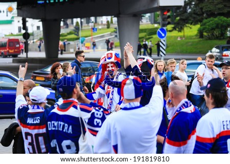 Minsk, Belarus - May 9,2014: Slovakia fan man in sports uniform screeming on a street face body art Slovakia flag at Ice Hockey World Championship Belarus Minsk 2014