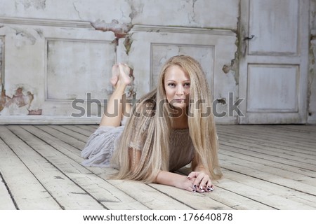 Portrait of young woman laying on floor