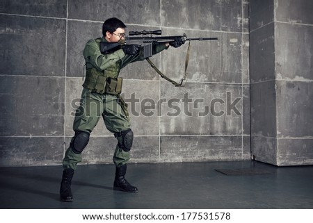 Soldier aiming the target with gun in building