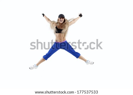 Fitness woman jumping of joy. Caucasian female model isolated on white background in full body