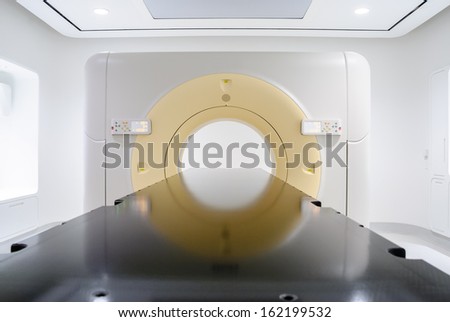 Head on view of CAT scan medical equipment in sterile white hospital room