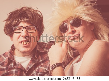 Vintage looking portrait of two wild and crazy guys wearing wigs and fake teeth.