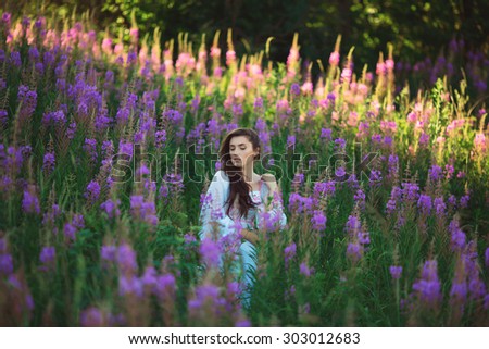 Beautiful provence woman relaxing in lavender field watching on sunset holding. Series. alluring girl with purple lavender. brunette lady in blossom field. Ukraine - Lviv