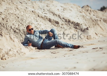 sun-tanned man lying on the sand