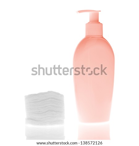 set of cosmetic bottles with cleaning pads isolated on white background