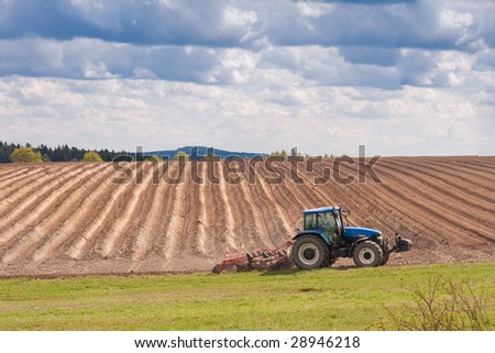 tractor planting potatoes in the springtime