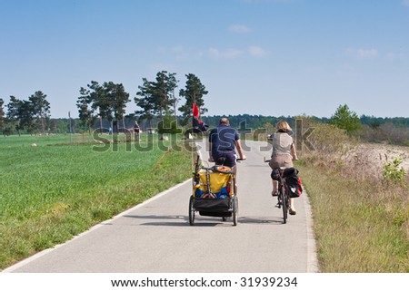 family cycling around the lake