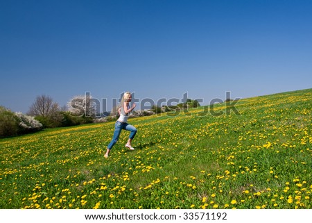 young female having fun on flowery meadow