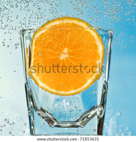 orange in the glass with mineral water