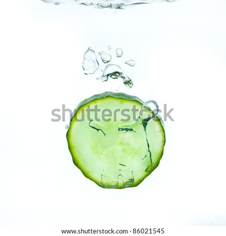 sliced cucumber splashing water isolated on white background