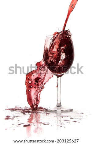 pouring red wine in goblet, isolated on white