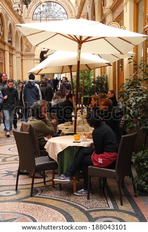 PARIS - MARCH 12: Tourists eat under umbrella in a small cafe in the beautifull  galerie Vivienne on March 12, 2011 in Paris, France. Paris is the most visited city in the world.