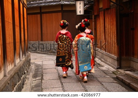 Three geishas walking on a street of Gion (Kyoto, Japan)