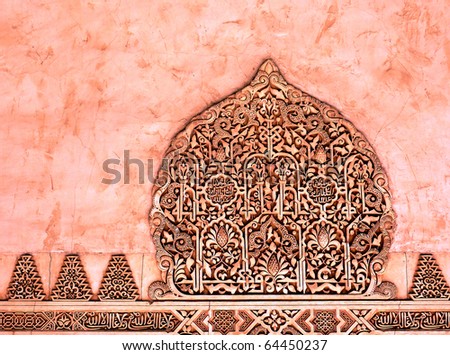 Decorative reliefs on red marble. Arabic art. In Spain one can find many traces of Islam culture. One of them is this beautiful sculpture placed in the very famous palace of Alhambra (Granada).