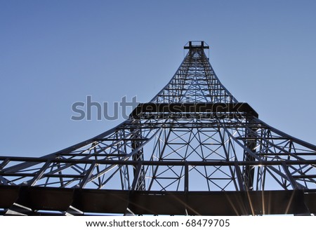 Telecommunication pole top on the clear sky background. This construction is very similar to famous Eiffel Tower in Paris