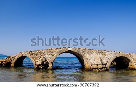 Surreal sea bridge. River dried, sea changed its coastline and the bridge\'s ruin is located in the middle of water. Argasi, Zakynthos
