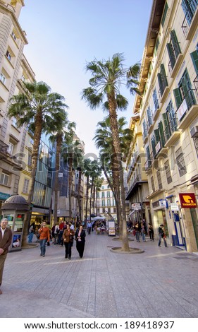 MALAGA - JUNE 12: City street view with cafeteria terraces and shops on June 12, 2013 in Malaga, Spain.
