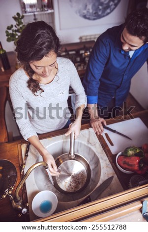 Young couple cooking. Man and woman in their kitchen